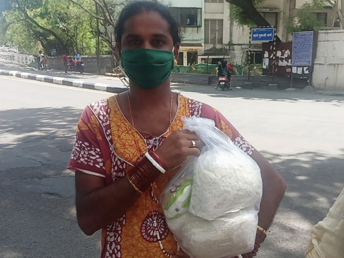 Transgender person receiving grocery aid during pandemic under women empowerment NGO in India
